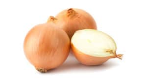 Three onions are pictured against a white background. Two of the onions are whole with their papery brown skins intact, while the third has been sliced in half, revealing the white layers within.