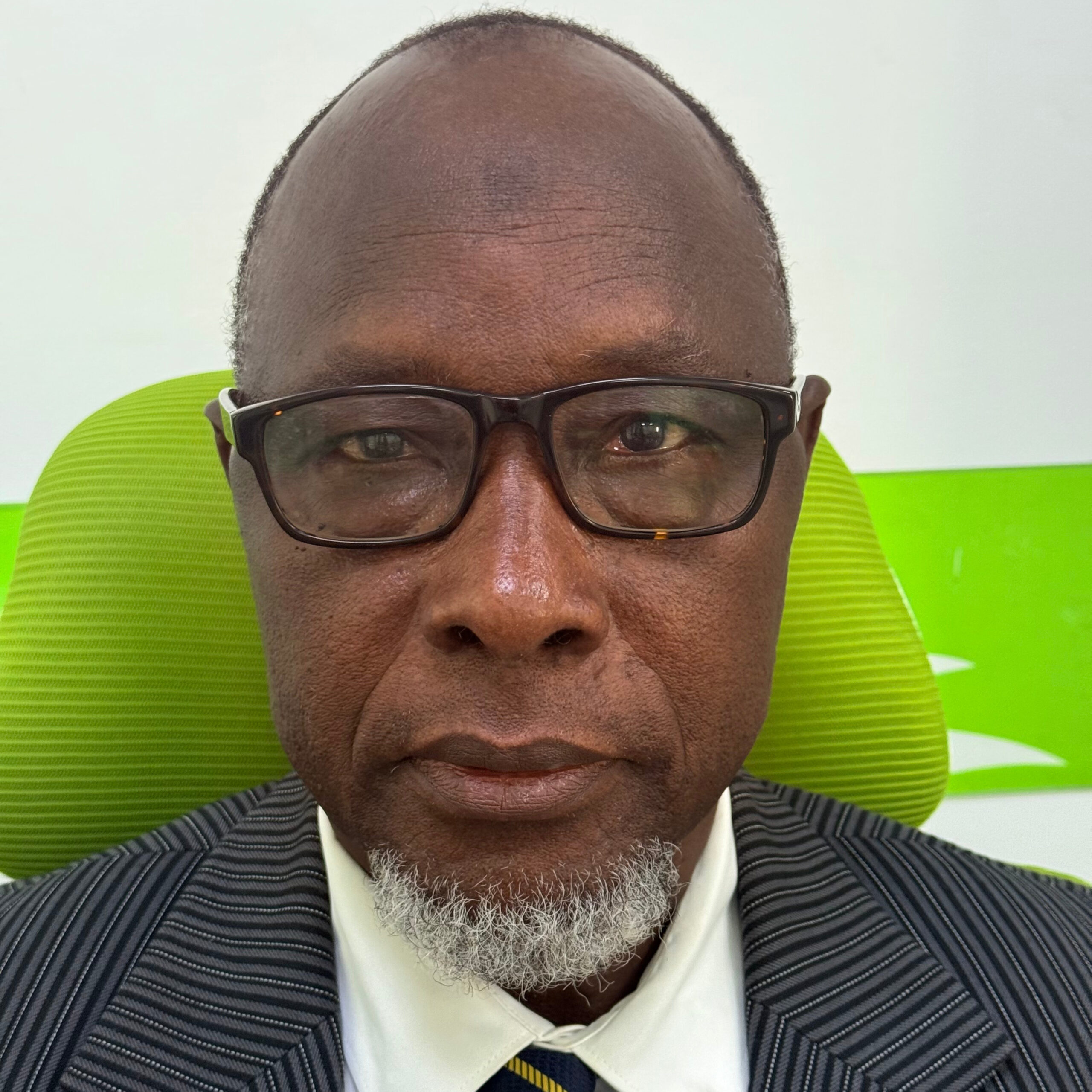 Saikou Juwara A stylized graphic of a green tree with four horizontal layers of leaves and a brown trunk, resembling a palm tree. The trunk is centrally aligned, and there is a green crescent shape at the bottom. A small green crescent sits at the top of the tree.